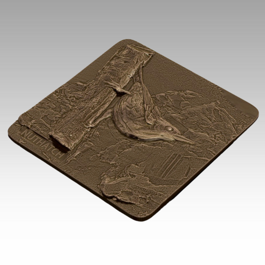 A bronze tactile relief of a nuthatch, showing its head-down posture and fine details to help visitors learn about native birds through touch.